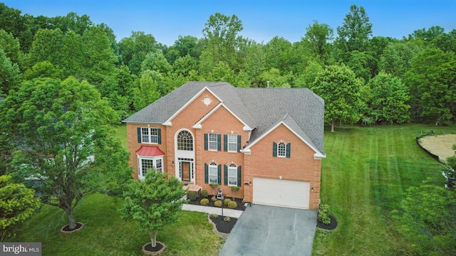 14014 Mary Bowie Pkwy, Upper Marlboro, MD 20774 - view of front of property with asphalt driveway, an attached garage, a front yard, a forest view, and brick siding