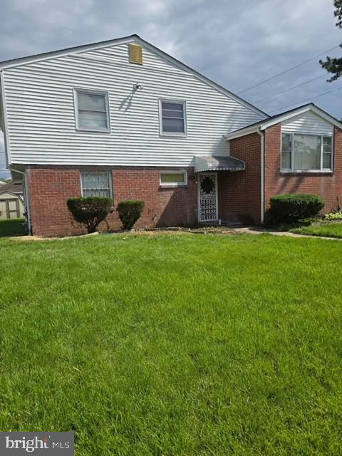 3403 Maryvale Rd, Baltimore, MD 21244 - rear view of property featuring a lawn and brick siding