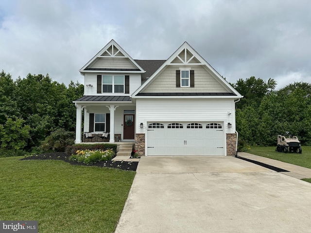 57 Oak Ln, Carneys Point, NJ 08069 - craftsman-style home with a standing seam roof, covered porch, driveway, a front lawn, and stone siding