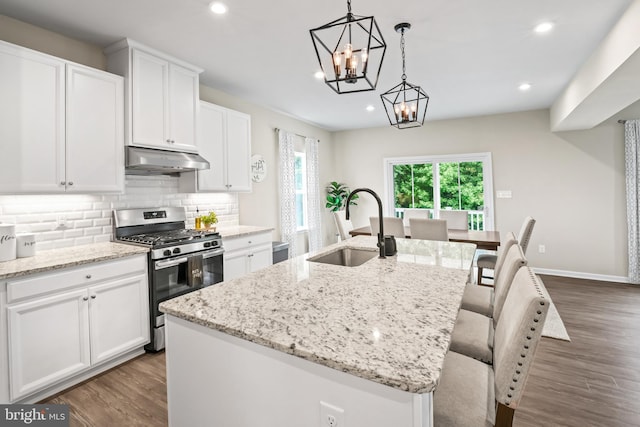 57 Oak Ln, Carneys Point, NJ 08069 - kitchen featuring stainless steel range with gas cooktop, under cabinet range hood, dark wood finished floors, an island with sink, and recessed lighting