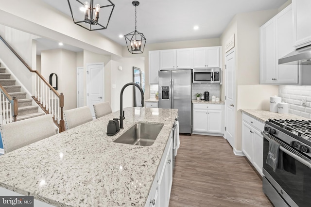 57 Oak Ln, Carneys Point, NJ 08069 - kitchen with stainless steel appliances, a chandelier, recessed lighting, tasteful backsplash, and white cabinetry