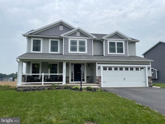 1403 Southwood Dr, Shippensburg, PA 17257 - view of front facade with asphalt driveway, a front yard, covered porch, a garage, and stone siding