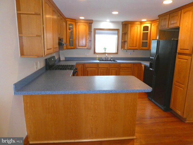 126 E Central Ave, Hammonton, NJ 08037 - kitchen featuring open shelves, black fridge with ice dispenser, gas stove, under cabinet range hood, and a peninsula