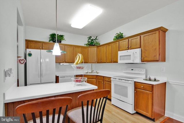 131 Sequoia Dr, Berlin, NJ 08009 - kitchen featuring white appliances, a peninsula, light wood-type flooring, and brown cabinets