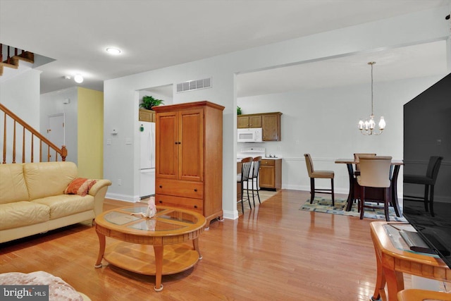 131 Sequoia Dr, Berlin, NJ 08009 - living area with light wood-style floors, stairs, and a chandelier