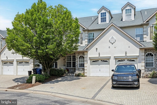 272 Center Point Ln, Lansdale, PA 19446 - view of front facade featuring decorative driveway, stucco siding, roof with shingles, and a garage