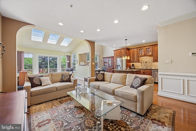 272 Center Point Ln, Lansdale, PA 19446 - living room featuring arched walkways, light wood-style flooring, recessed lighting, a wainscoted wall, and ornamental molding
