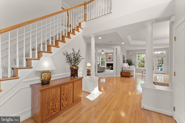 43665 Jernigan Ter, Leesburg, VA 20176 - staircase with ornate columns, wood finished floors, recessed lighting, a ceiling fan, and a tray ceiling