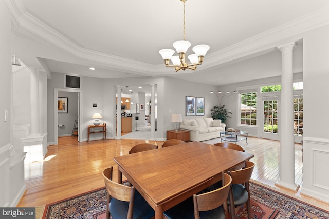 43665 Jernigan Ter, Leesburg, VA 20176 - dining space featuring ornate columns, light wood finished floors, crown molding, and a chandelier