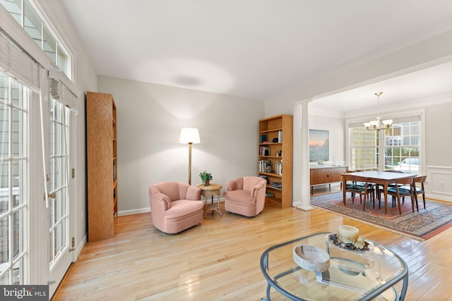 43665 Jernigan Ter, Leesburg, VA 20176 - living area featuring wood-type flooring, a chandelier, and ornamental molding