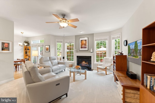 43665 Jernigan Ter, Leesburg, VA 20176 - carpeted living area with a fireplace with flush hearth, ceiling fan, and a chandelier