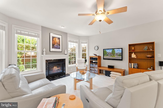 43665 Jernigan Ter, Leesburg, VA 20176 - carpeted living room with a fireplace with flush hearth, healthy amount of natural light, and a ceiling fan