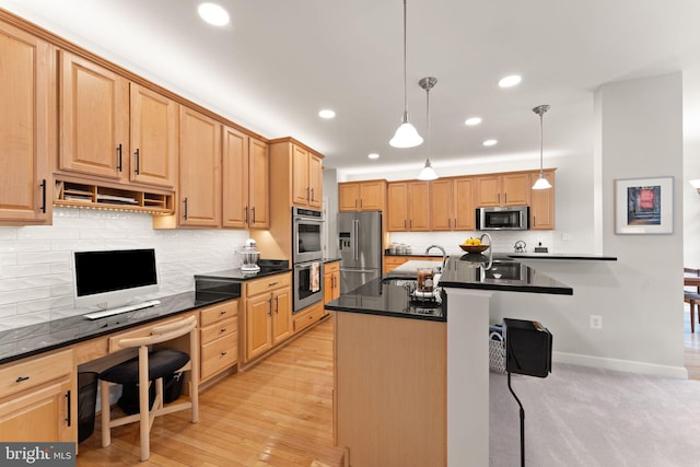 43665 Jernigan Ter, Leesburg, VA 20176 - kitchen with stainless steel appliances, dark countertops, recessed lighting, backsplash, and built in desk