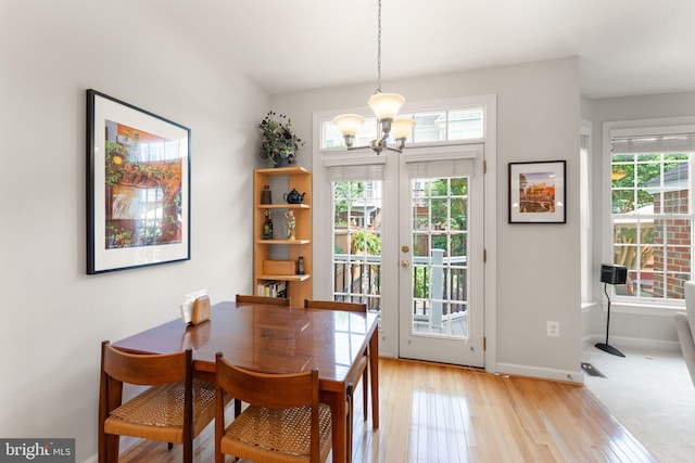 43665 Jernigan Ter, Leesburg, VA 20176 - dining room with a chandelier, healthy amount of natural light, and light wood-style flooring