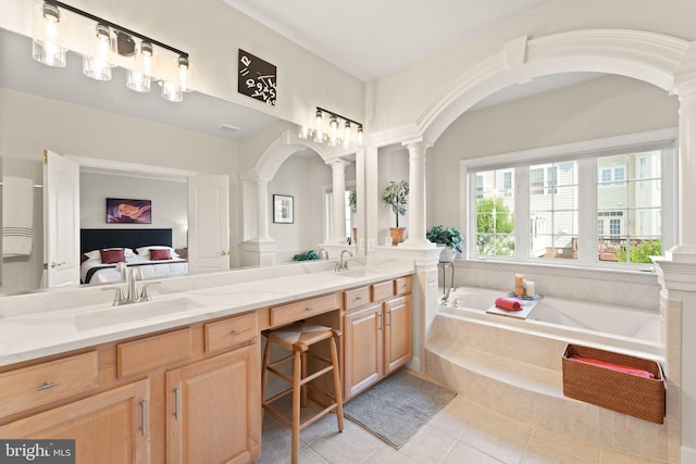 43665 Jernigan Ter, Leesburg, VA 20176 - full bath featuring decorative columns, ensuite bath, a garden tub, tile patterned floors, and double vanity