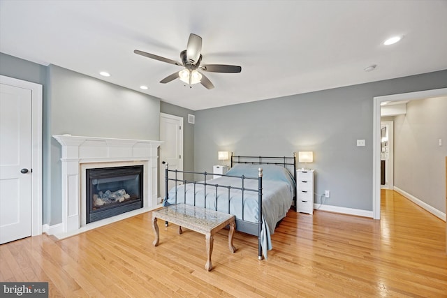 121 Valley Pl, Media, PA 19063 - bedroom with light wood-type flooring, recessed lighting, a glass covered fireplace, and ceiling fan