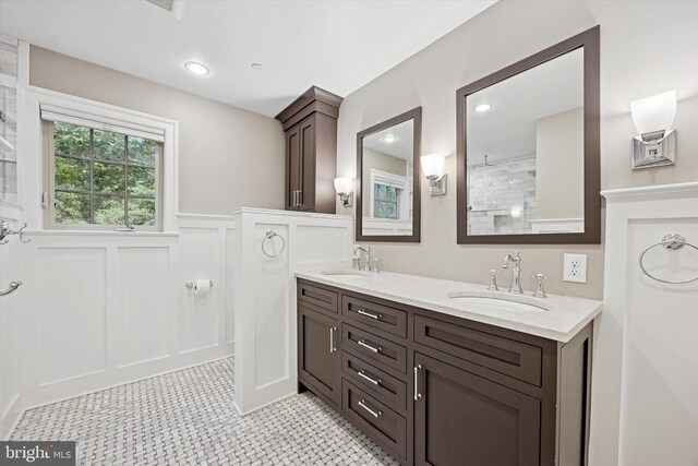 121 Valley Pl, Media, PA 19063 - full bath with double vanity, a decorative wall, a wainscoted wall, and a tile shower