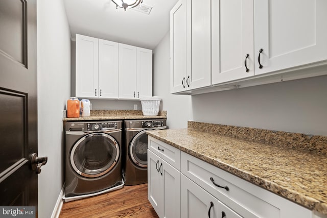 407 Independence Ave SE, Washington, DC 20003 - washroom featuring separate washer and dryer, cabinet space, and wood finished floors