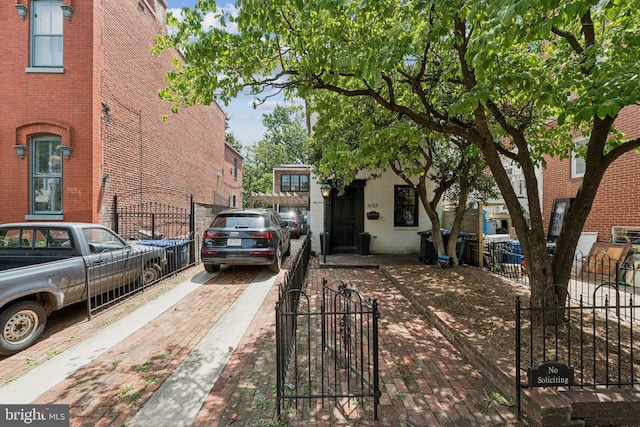 407 Independence Ave SE, Washington, DC 20003 - view of side of home with brick siding, a fenced front yard, and a gate