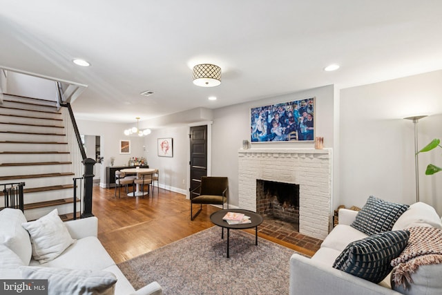 407 Independence Ave SE, Washington, DC 20003 - living room with stairs, a chandelier, recessed lighting, a fireplace, and wood finished floors