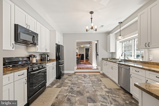 407 Independence Ave SE, Washington, DC 20003 - kitchen with black appliances, a chandelier, white cabinets, decorative light fixtures, and dark stone countertops