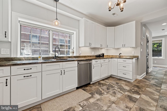 407 Independence Ave SE, Washington, DC 20003 - kitchen featuring dishwasher, white cabinets, dark stone finish flooring, a chandelier, and pendant lighting