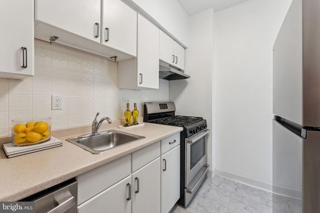 1711 Massachusetts Ave NW Unit 230, Washington, DC 20036 - kitchen with appliances with stainless steel finishes, under cabinet range hood, light marble finish flooring, light countertops, and white cabinets