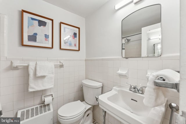 1711 Massachusetts Ave NW Unit 230, Washington, DC 20036 - bathroom with radiator, tile walls, and wainscoting