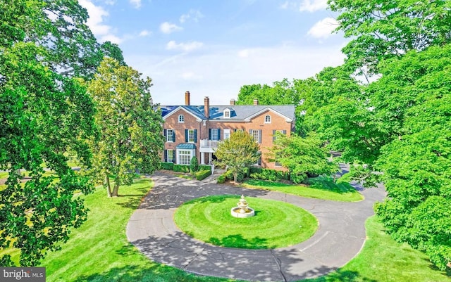 4367 Sunset Ct, Warrenton, VA 20187 - colonial house featuring curved driveway, a chimney, and a front yard