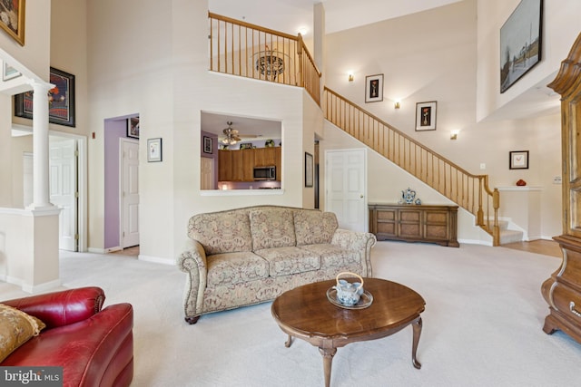 6230 Glen Valley Ter Unit 4L, Frederick, MD 21701 - living area with ornate columns, carpet floors, stairs, and a towering ceiling