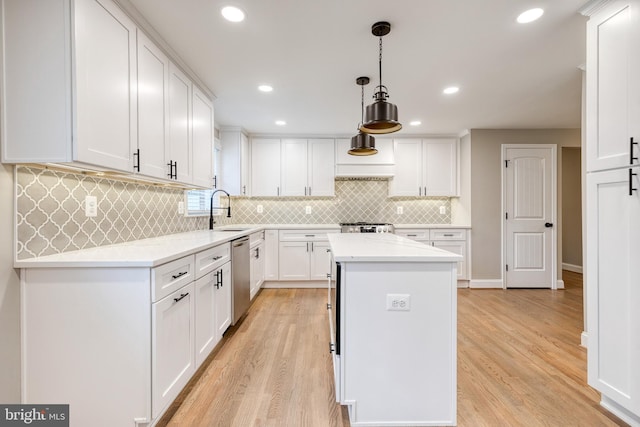 2100 Pot Spring Rd, Lutherville Timonium, MD 21093 - kitchen with a center island, light wood-style flooring, white cabinets, stainless steel dishwasher, and backsplash