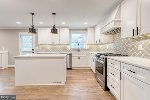 2100 Pot Spring Rd, Lutherville Timonium, MD 21093 - kitchen with stainless steel appliances, ornamental molding, a kitchen island, white cabinets, and tasteful backsplash
