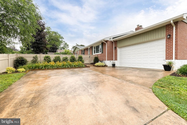 2100 Pot Spring Rd, Lutherville Timonium, MD 21093 - view of home's exterior with brick siding, a chimney, an attached garage, and driveway