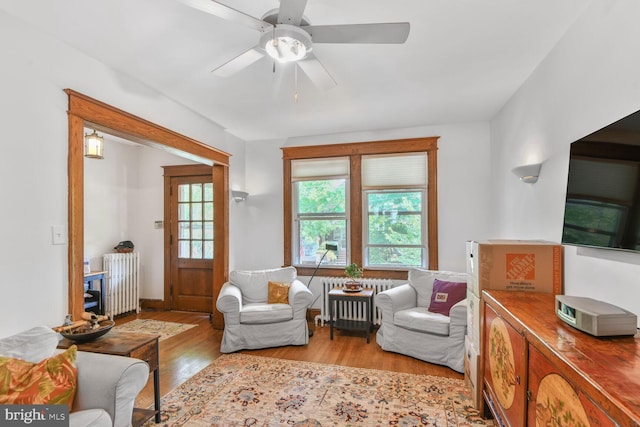 3905 Benton St NW, Washington, DC 20007 - living room with radiator heating unit, wood finished floors, and a ceiling fan