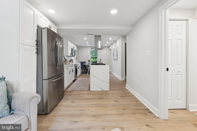 9215 Glenville Rd, Silver Spring, MD 20901 - kitchen with appliances with stainless steel finishes, island range hood, white cabinets, light wood-type flooring, and recessed lighting