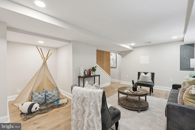 9215 Glenville Rd, Silver Spring, MD 20901 - living area with electric panel, wood finished floors, recessed lighting, and stairs