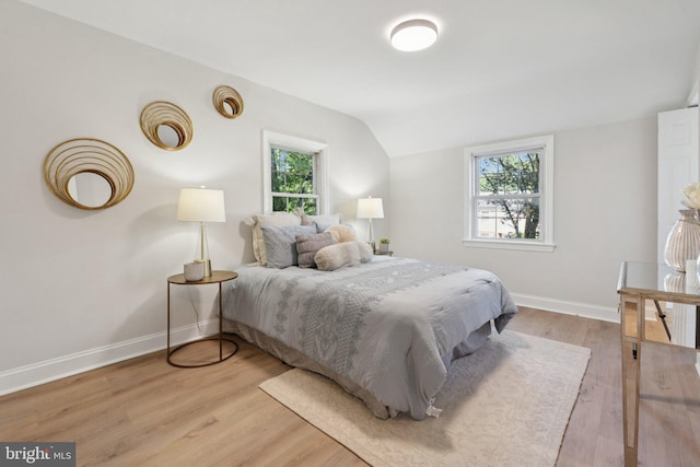 9215 Glenville Rd, Silver Spring, MD 20901 - bedroom featuring multiple windows, lofted ceiling, and light wood-style floors