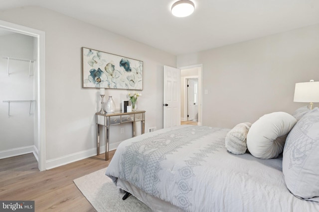 9215 Glenville Rd, Silver Spring, MD 20901 - bedroom featuring a walk in closet, light wood-type flooring, and a closet