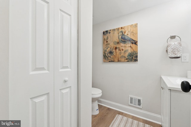 9215 Glenville Rd, Silver Spring, MD 20901 - bathroom featuring vanity, a closet, and wood finished floors