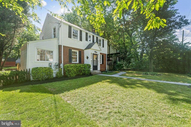 9215 Glenville Rd, Silver Spring, MD 20901 - colonial-style house featuring brick siding and a front lawn