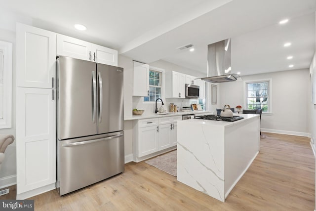 9215 Glenville Rd, Silver Spring, MD 20901 - kitchen featuring stainless steel appliances, island exhaust hood, a kitchen island, white cabinets, and recessed lighting