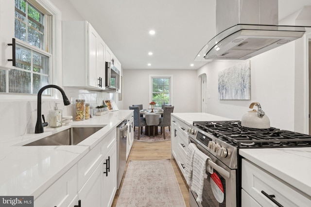 9215 Glenville Rd, Silver Spring, MD 20901 - kitchen featuring stainless steel appliances, ventilation hood, light wood finished floors, light stone counters, and recessed lighting