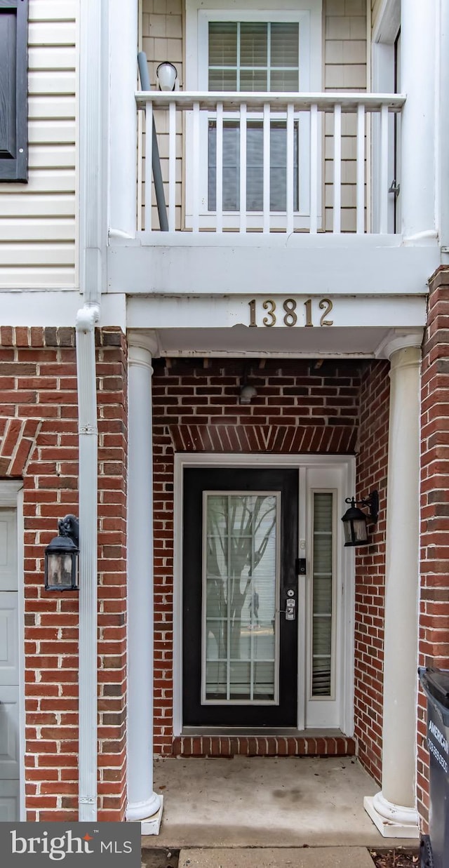 13812 Breezy Ridge Way Unit 101, Woodbridge, VA 22191 - view of exterior entry featuring a balcony and brick siding