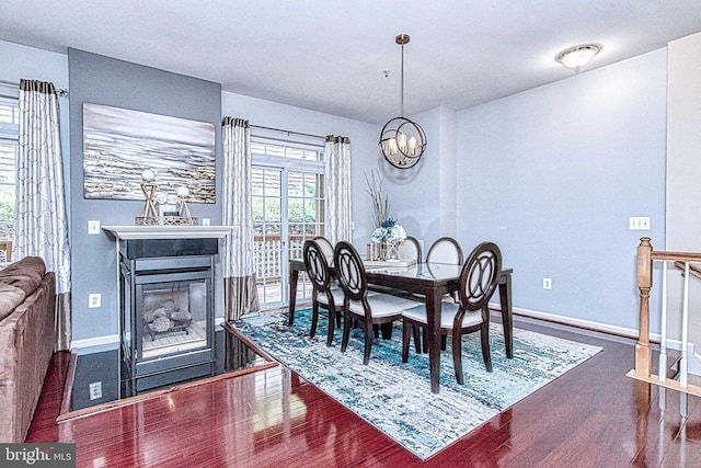 13812 Breezy Ridge Way Unit 101, Woodbridge, VA 22191 - dining area with wood finished floors, a multi sided fireplace, and a chandelier