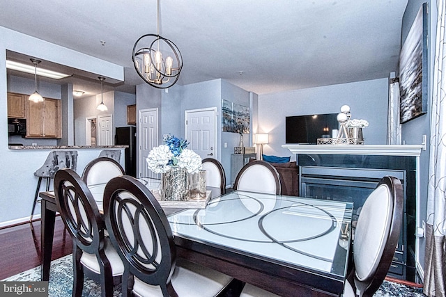 13812 Breezy Ridge Way Unit 101, Woodbridge, VA 22191 - dining space with a chandelier, wood finished floors, and a fireplace