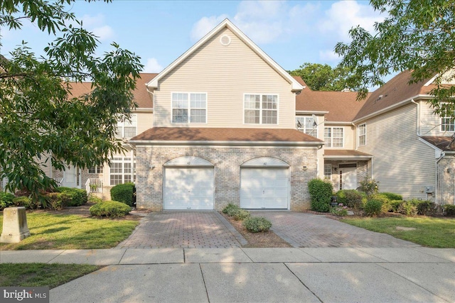 42 Frost Ln, Hightstown, NJ 08520 - traditional-style house featuring decorative driveway, brick siding, and an attached garage