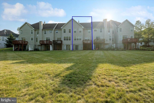 42 Frost Ln, Hightstown, NJ 08520 - back of property featuring a chimney, a lawn, a wooden deck, and a residential view