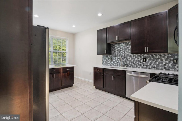 42 Frost Ln, Hightstown, NJ 08520 - kitchen featuring stainless steel appliances, tasteful backsplash, light countertops, light tile patterned floors, and dark brown cabinetry