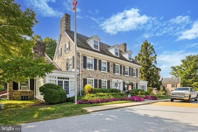 432 Old Forge Xing Unit 432, Devon, PA 19333 - colonial house with stone siding, a chimney, and a front yard