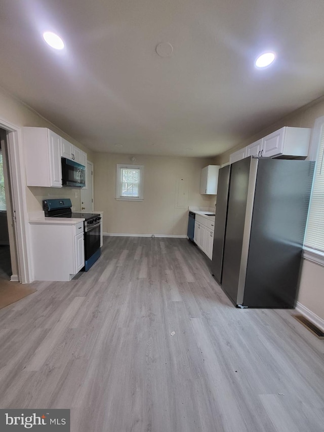 501 Tunstall Ave, Blackstone, VA 23824 - kitchen featuring black appliances, white cabinetry, light wood-type flooring, light countertops, and recessed lighting